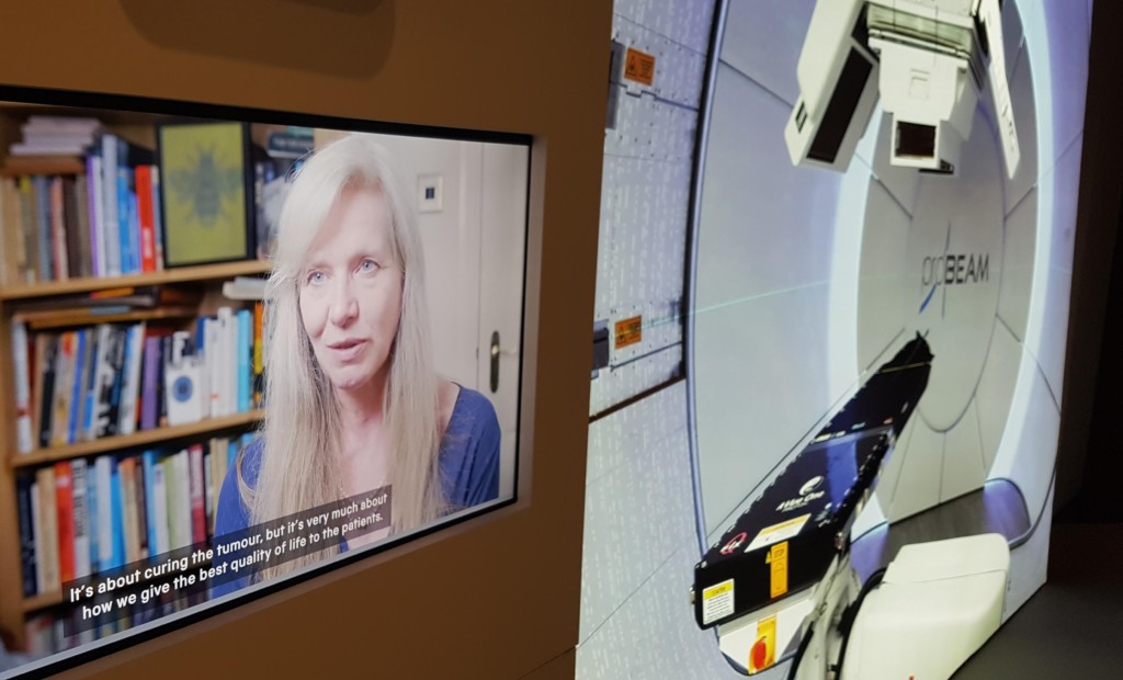 Image shows a Cancer Revolution exhibit display featuring Professor Karen Kirkby and Proton Beam Therapy